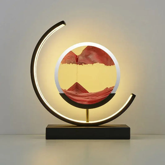 Eine 'Luce del Cerchio' Nachttischlampe mit modernem, kreisförmigem Design und sanfter LED-Beleuchtung auf einem Buch platziert.